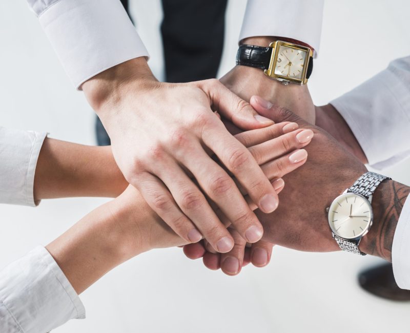 people-putting-stacked-hands-together-promising-help-support-against-white-backdrop